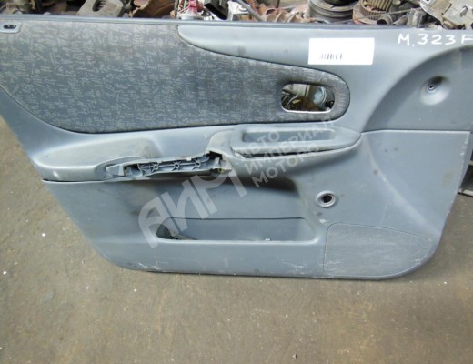 Обшивка двери передней левой (дверная карта)  Mazda 323 VI (BJ) 1998-2003